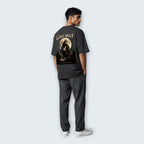 WOFF unisex oversized charcoal cotton t-shirt with Lone Wolf graphic print on back, worn by a man