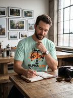 WOFF unisex mint green cotton crew neck t-shirt with Alpha Life wolf graphic print worn by a man writing in a journal
