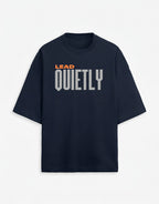 WOFF navy oversized unisex tee with drop shoulders and Lead Quietly graphic in orange and grey text.