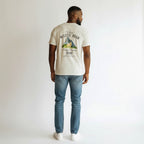 White 100% cotton WOFF t-shirt with a graphic of a wolf standing in front of mountains and text that reads "Where Wolves Roam Strength Becomes Home."