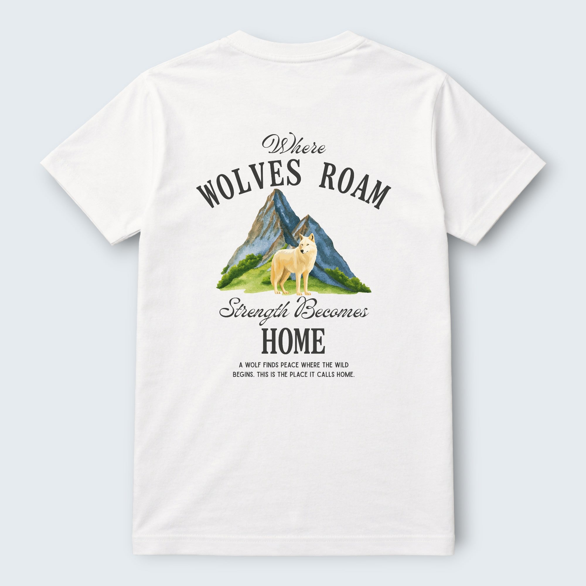 White 100% cotton crew neck t-shirt from WOFF featuring a graphic print of a wolf standing in front of mountains with the text "Where Wolves Roam" and "Strength Becomes Home".