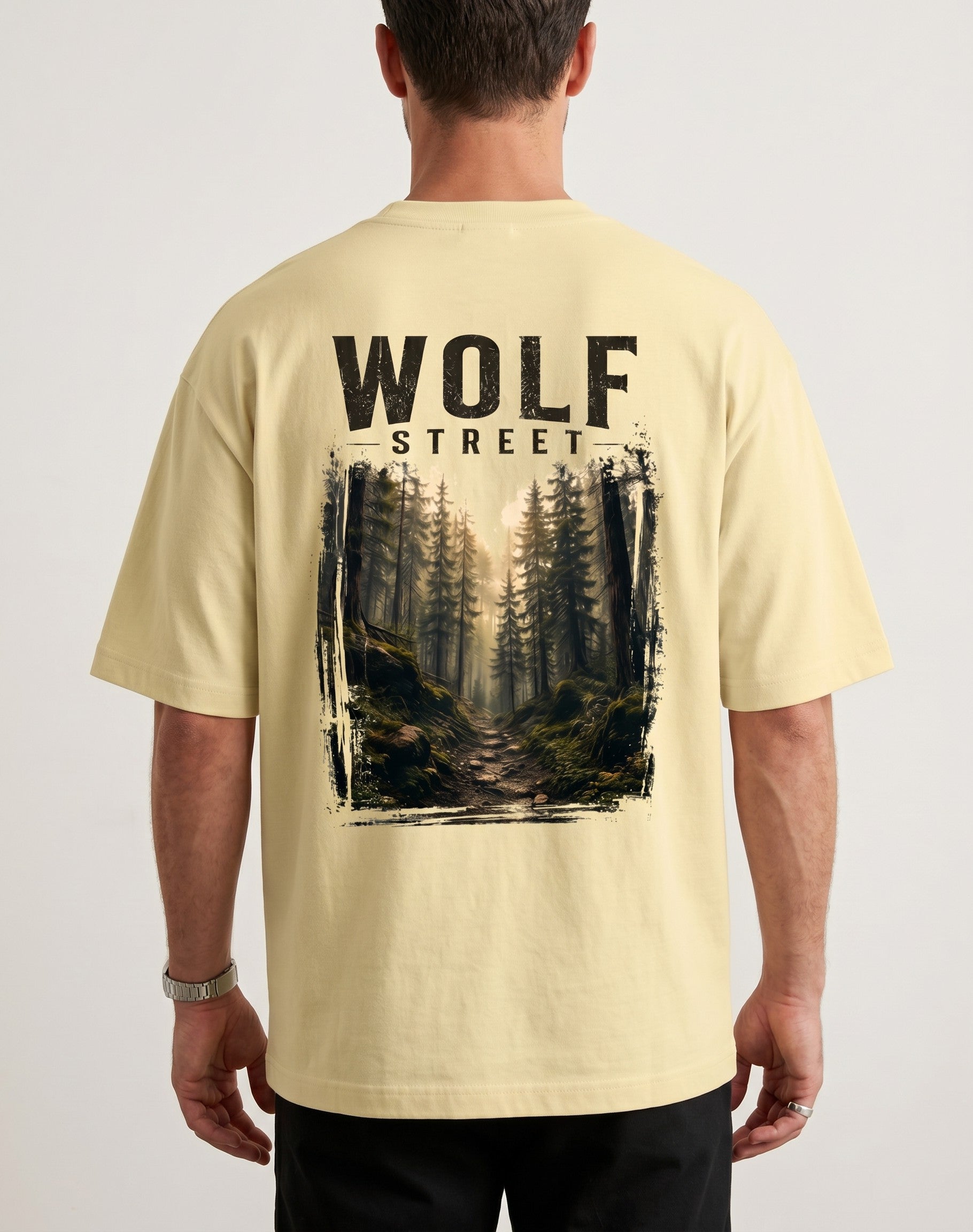 WOFF Wolf Street oversized cotton t-shirt in cream with a forest graphic print on the back worn by a man